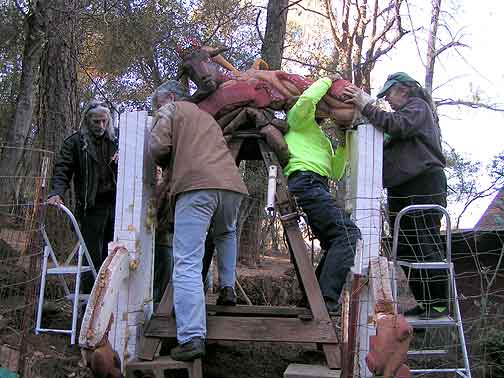 Volunteers raise the top section of the Mushroom Wedding Arch